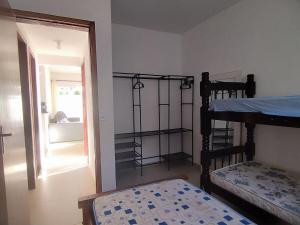 a bedroom with two bunk beds and a doorway at Casa 1 Vila do Peró in Cabo Frio +2 photos