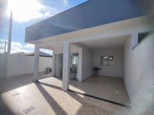 a large white house with the sun in the background at Casa 1 Vila do Peró in Cabo Frio