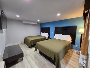 a hotel room with two beds and a tv at Budget inn North Myrtle Beach in Myrtle Beach