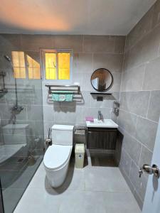 a bathroom with a toilet and a sink and a shower at Casa Madome in Pedernales +25 photos