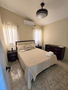 a bedroom with a large bed and two night stands at Casa Madome in Pedernales