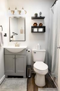 a bathroom with a sink and a toilet and a mirror at Meadow View BNB in Lima