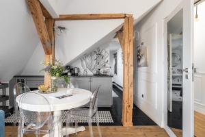 CHILLSET Apartmenty Westerplatte by Lion Apartments في سوبوت: غرفة طعام مع طاولة بيضاء وكراسي +27 صورة