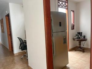 a kitchen with a refrigerator and a table at Casa El Pinar in Jardin