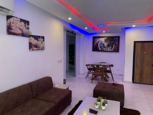 a living room with a couch and a table at Presken Luxury Apartments in Lagos +21 photos
