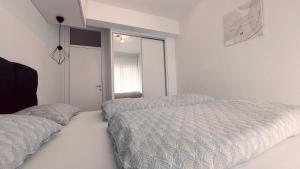 a bedroom with two beds and a window at Apartman Petra in Čapljina