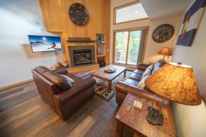 a living room with a couch and a fireplace at Ski Run 303 by SummitCove Lodging in Keystone