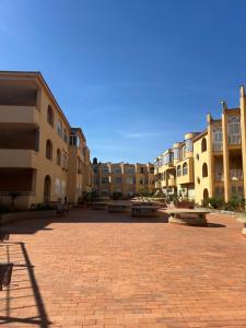 a brick courtyard with a bunch of buildings at Chris House Mondello in Palermo