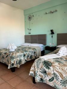 a hotel room with two beds in a room at Hotel Marcianito in Isla Mujeres +109 photos