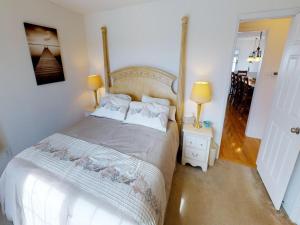 a bedroom with a large white bed with two lamps at Roof-Top Deck With Ocean & Bay Views Single Family Beach Badges Private Yard Ping Pong And Pool Table Wifi 1 Block From Ocean 15 Blocks To Bay in Ship Bottom