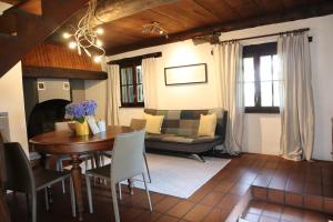 a living room with a table and a couch at Verzasca Lodge Cassiopea in Frasco