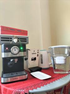 a counter with a coffee maker and a blender on it at B&B La Villetta Salerno Airport in Montecorvino Pugliano