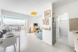 a kitchen and living room with a view of the ocean at Lolas in Puerto del Carmen
