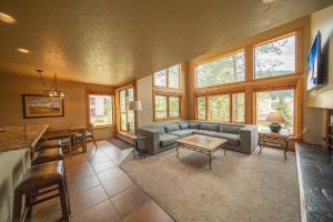a living room with a couch and a table at Quicksilver 1635 by SummitCove Lodging in Keystone