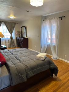 a bedroom with a large bed and a large window at Hayward Home in Hayward