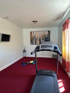 a room with a treadmill and a red carpet at Hayward Home in Hayward