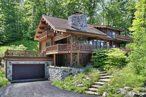 a large house with a garage in front of it at Viewtopia in Suttons Bay
