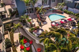 an overhead view of a hotel with a pool and palm trees at Luxury Open BD w Pool, Parking, & WD 133 in Los Angeles