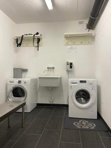a laundry room with a washing machine and a sink at Residenz Max mit eigenem Garten in Seefeld in Seefeld in Tirol
