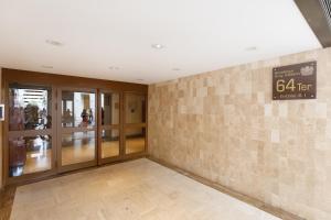 a lobby with glass doors and a sign on a wall at Gray d'Albion 3i7 YourHostHelper in Cannes