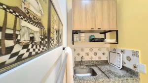 a kitchen with a sink and a counter top at Home Beach in Maragogi