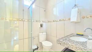 a white bathroom with a toilet and a sink at Home Beach in Maragogi +36 photos