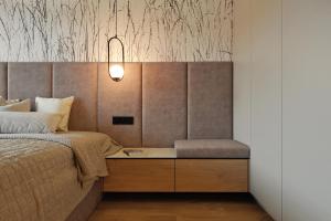 a bedroom with a bed and a desk with a chair at Apartment Magnolia Marina Lux & SPA in Dziwnów