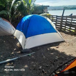 a tent sitting on the ground next to a body of water at Beach view tent in Port Antonio