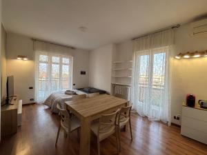 a bedroom with a bed and a wooden table at SkyLoft Bergamo - Attico Chic con Panorama Unico in Bergamo