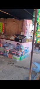 a store with a bunch of drinks on a shelf at Triveni hotel & restaurant natawala Shahpura in Shāhpura