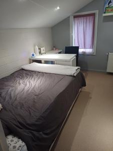 a bedroom with a large bed and a desk at country house in Provence in Pierrevert