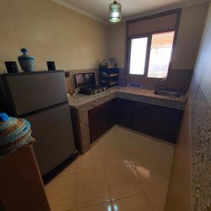 a kitchen with a refrigerator and a window at The View in Taghazout