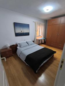a bedroom with a large bed and a tv on the wall at BRISAS DEL MAR Eddy,,AIR,WIFI in Candelaria