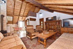 a living room with a couch and a tv at Apartments Pegaz in Virpazar