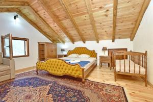 a bedroom with a large bed and a wooden ceiling at Apartments Pegaz in Virpazar +31 photos