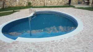a small swimming pool with a staircase in the middle at Apartments Pegaz in Virpazar