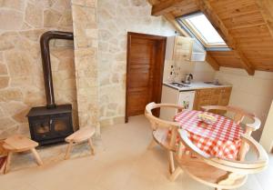 a kitchen and dining room with a table and a stove at Apartments Pegaz in Virpazar