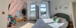 a bedroom with a bed and a large window at Treheveras Guest House in Newquay
