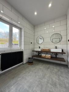 a bathroom with two sinks and a large window at Čisté a příjemné ubytování in Teplice