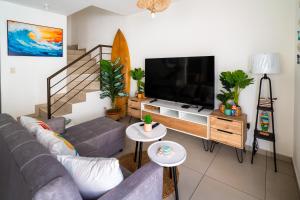 a living room with a couch and a flat screen tv at Casa Surf in Zaragoza