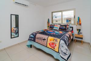 a bedroom with a bed and a window and a surfboard at Casa Surf in Zaragoza +50 photos