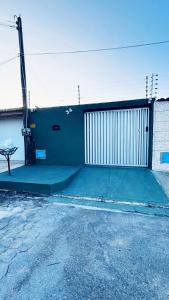 a building with a gate and a parking lot at Marcanau in Maracanaú
