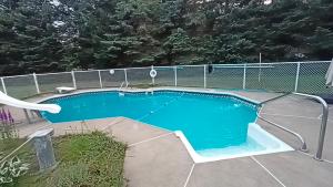 a swimming pool with a fence around it at Cottage with inground pool outside in Saint-Damien