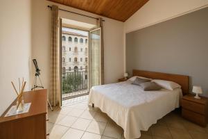 a bedroom with a bed and a large window at Jacuzzi Suite in Livorno +17 photos