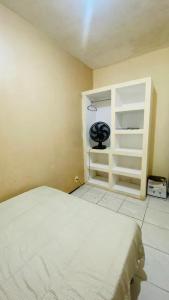 a bedroom with a bed and an open cabinet at Marcanau in Maracanaú