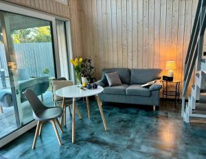 a living room with a couch and a table at domek w stylu stodoły in Narty +14 photos