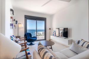 a living room with a view of the ocean at RentitSpain Playa, piscina y terraza al mar in La Herradura
