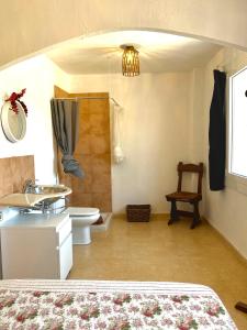 a bedroom with a bathroom with a toilet and a sink at Casa La Alegria in Maçanet de la Selva