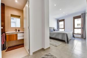 a bedroom with a bed and a bathroom at Flat 58 - City Center Moraira in Moraira +24 photos
