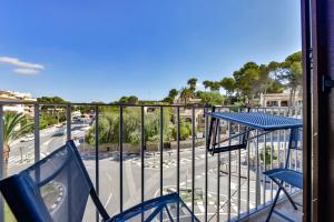a balcony with blue chairs and a view of a street at Flat 58 - City Center Moraira in Moraira